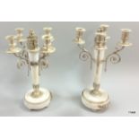 A pair of 19thc silver plated and marble four branch candelabras with the central column in the form