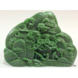 A chinese carved jade tablet depicting figures in a village