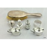 A collection of silver items to include 2 mustards with liners, salt and pepper and brush