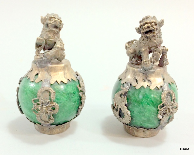 A pair of Chinese hardstone vases with dogs of foe to the top