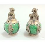 A pair of Chinese hardstone vases with dogs of foe to the top