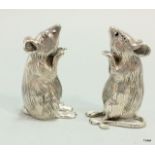 A pair of solid silver mouse condiments