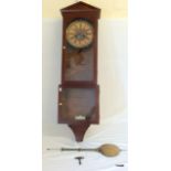 A mahogany pendulum clock with key