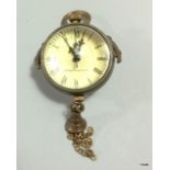 A brass miniature ball clock