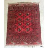 A red, black and cream Iranian rug with cream and black border 130 x 105cm