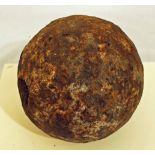 An 18th century cast iron cannon ball approximately 6.5 inches diameter with a weight of