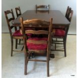 A mahogany extending table with 6 chairs to include carvers with ladder backs