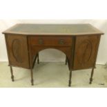 A leather topped writing table on turned legs with a single drawer and two side cupboards. 74 x
