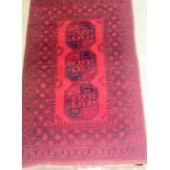 A red and black Iranian rug with octagonal centre pattern 180 x 110cm