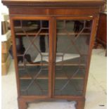 A mahogany glazed adjustable shelf bookcase with Chevron fit glass doors and shaped top 120 x 84 x