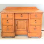 A pine 7 drawer cupboard with glass handles on bun feet