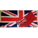 A large cloth Union Jack flag 36 inches by 72 inches approximately and a cloth Red Ensign 17