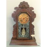 An oak cased pendulum clock with key and pendulum by Ansonia Clock Co. New York, United Sates of