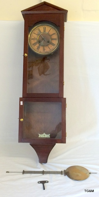 A mahogany pendulum clock with key