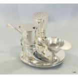 Unusual silver plated condiment set in the form of two boots on a strip shaped base