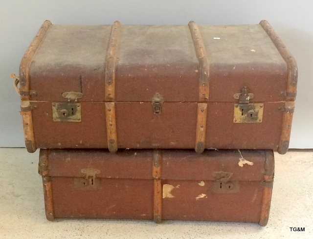 A pair of wood bound travelling trunks