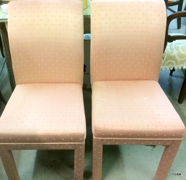 A pair of upholstered high backed dining chairs