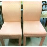 A pair of upholstered high backed dining chairs