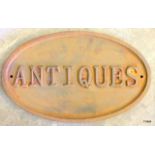 A large rust antiques sign