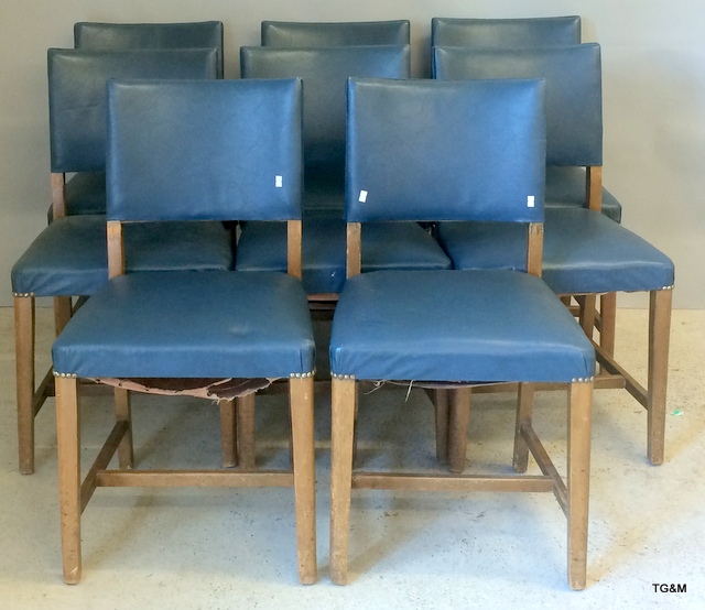 A set of 8 dining chairs with blue Rexine covers