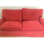 A velour covered red 3 seater settee