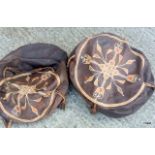 A pair of leather pouffes