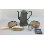 A pewter coffee pot with a crumb brush and tray with 2 wine coasters the crumb brush has a silver