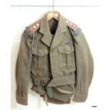 An Army military battle dress uniform 1949 pattern to include lanyard and whistle