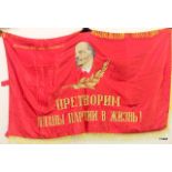 An old Russian cold war flag featuring the head of Soviet political hero Vladimir Ilyich Lenin. On