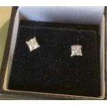 A pair of silver and CZ stud earrings