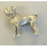 A silver figure of a boxer dog