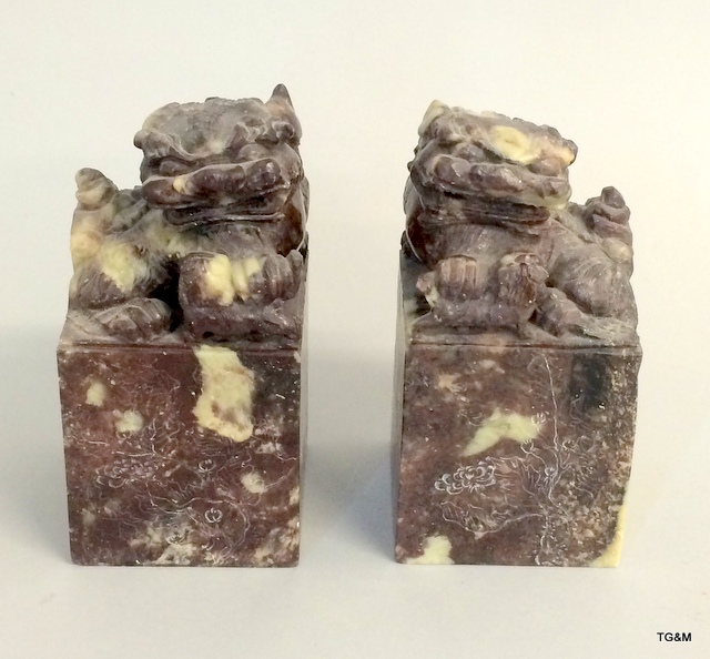 A pair of large Chinese soapstone desk seals with engraved decoration to all four sides.