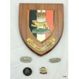 A silver military badge together with a plaque, lapel badges etc from the Royal Leicestershire