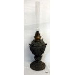 A Victorian cast metal oil lamp with embossed military scene decoration
