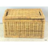 A honey rattan storage basket with lid. 40 x 70 x35.