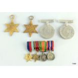 A WW2 group of four medals including the Burma Star with a mounted set of miniature medals