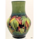 A Moorcroft leaves and berries vase 35cm high x 14cm in neck x 14cm base