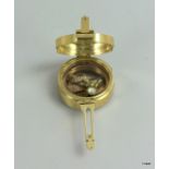 a brass cased compass and sun dial