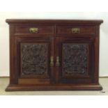 Art Nouveau twin door twin draw side board with carved inset front panels and brass handles