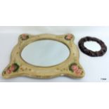 A pair of ornately carved and painted wall mirrors