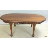Dark mahogany oval coffee table with carved surround. 45 x 25 x 60cm