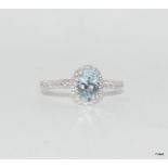 an 18ct white gold aquamarine and diamond cluster of 1.1ct Size M