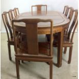 A Chinese hard wood extending table with 8 chairs, 80x200x115cm