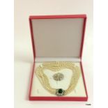 A cased diamonte and pearl necklace and brooch set