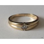 A ladies 9ct gold 0.1ct diamond band ring size o