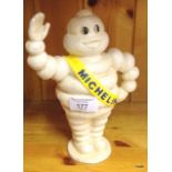 A waving Michelin man figure