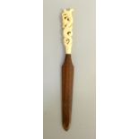 Ivory Carved Handled Page Turner with a wooden blade depicting rams head. 26cm long