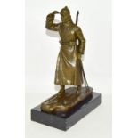 a bronze figure of a soldier on skis, set on a marble base. 26cm high