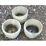 Three round concrete garden pots