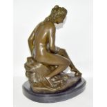 A bronze figure of a naked lady bathing, set on a marble base. 32cm tall